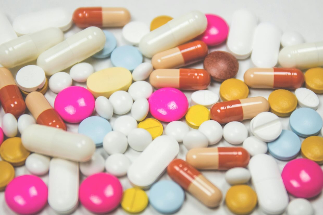 A pile of different pills and medication.