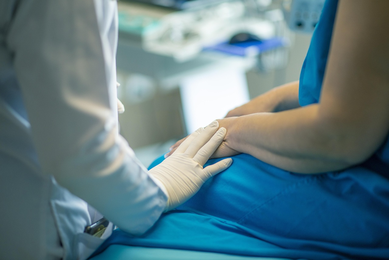 doctor with hand on patient in operating room.